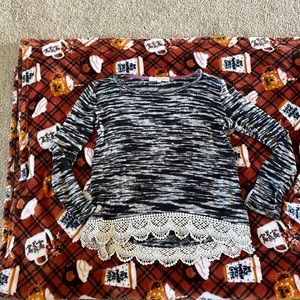 Black and cream color shirt. Sleeves run a little shorter. No rips or tears